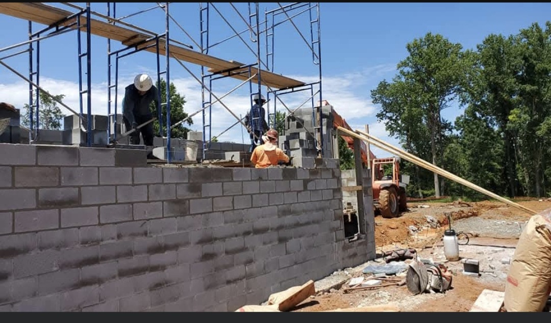 SLP Masonry team working on a masonry wall